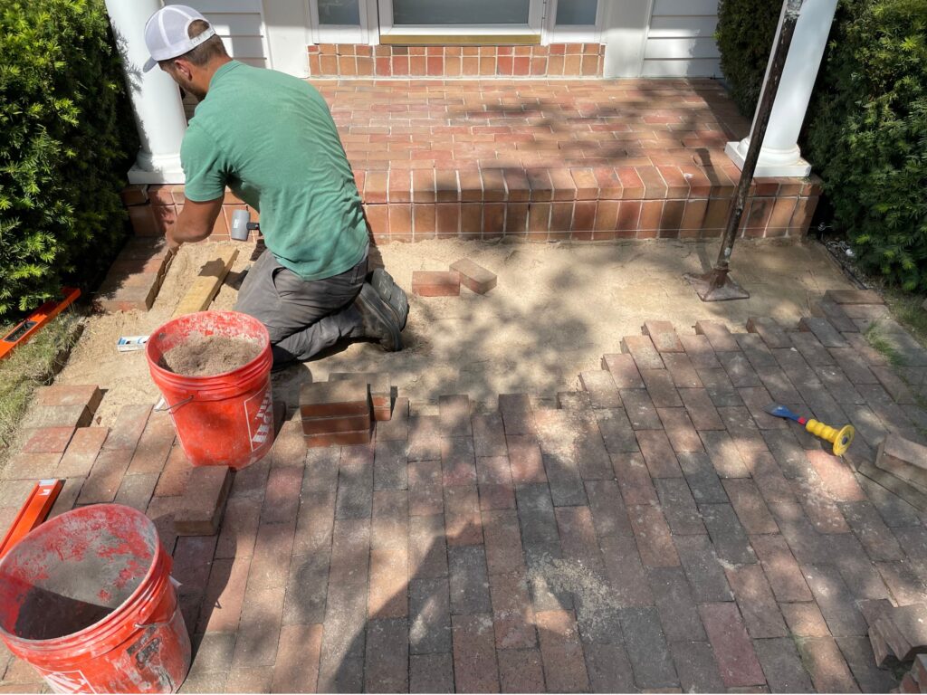 man doing flatwork with bricks